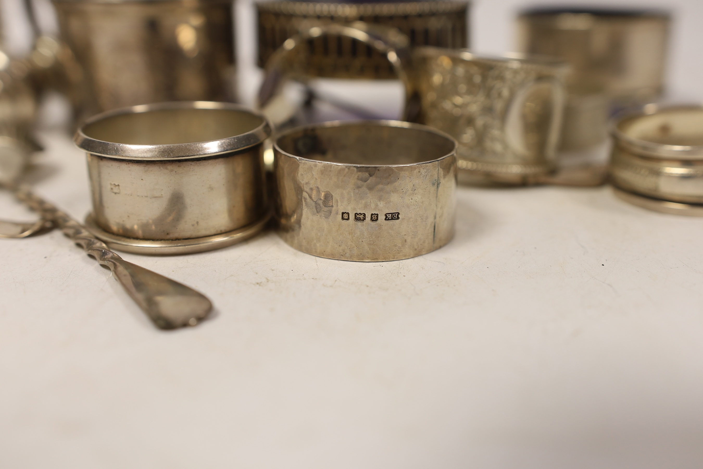 A small group of sundry silver including nine assorted napkin rings, five assorted condiments including Georgian oval salt, a small silver scent bottle, three small silver spoons and four plated items.